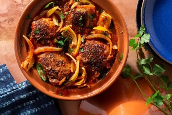 Spinach Enchiladas baked in a dish with tomato sauce and melted cheese, a vegetarian family meal popular in South Africa