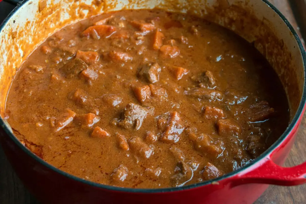Domada Gambian peanut stew with chicken and sweet potato in a pot, Gambia's national dish