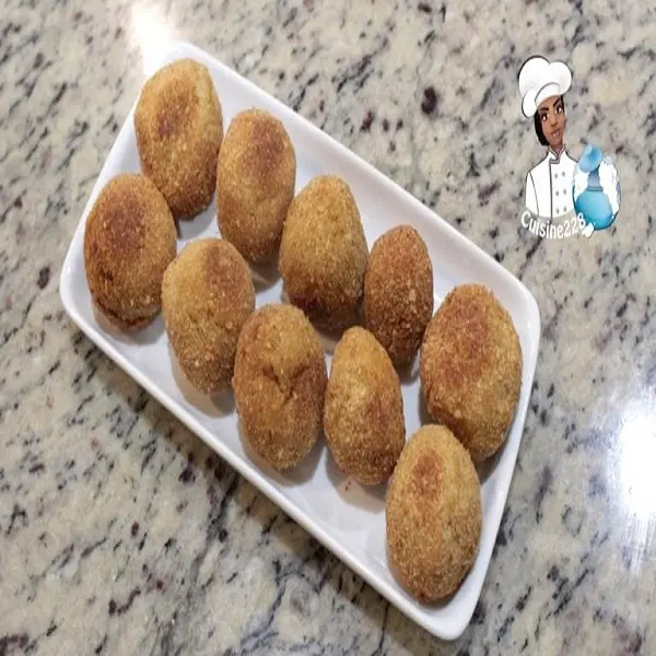 Crispy homemade chicken nuggets on a plate with dipping sauce, a South African family favourite snack