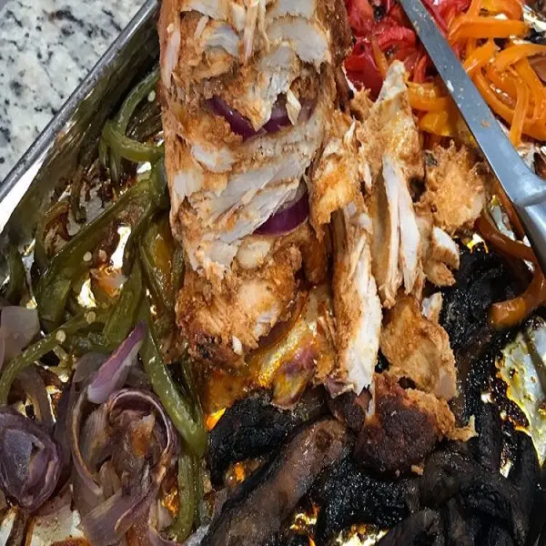 Homemade Chicken Shawarma wrapped in flatbread with garlic sauce and vegetables, North African style spiced chicken