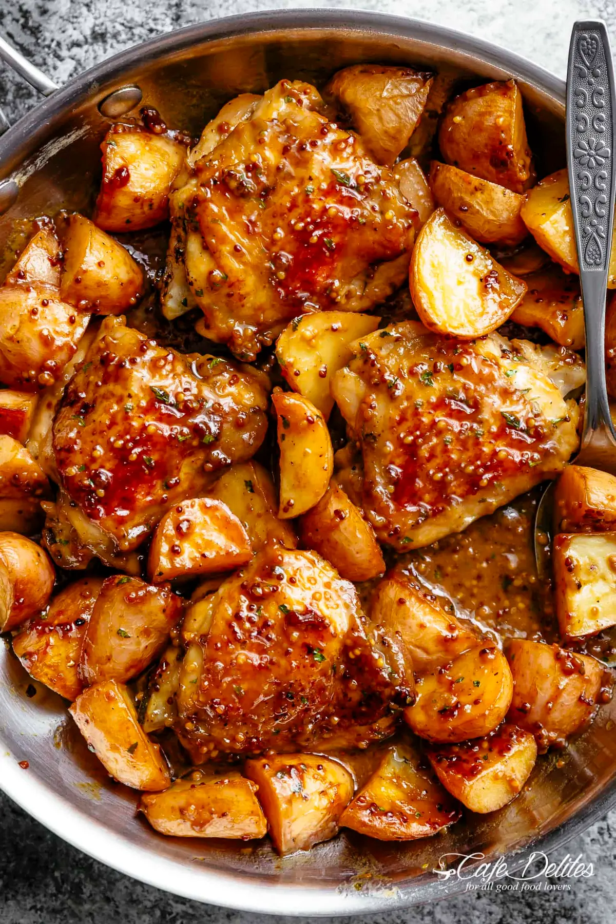 South African Mustard Chicken and Potatoes baked golden in a roasting dish with a tangy mustard marinade