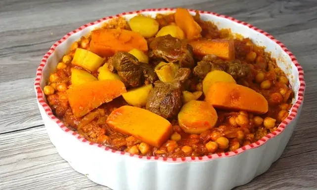 Libyan Couscous with lamb, chickpeas, and vegetables in a rich spiced broth, a traditional North African celebration dish