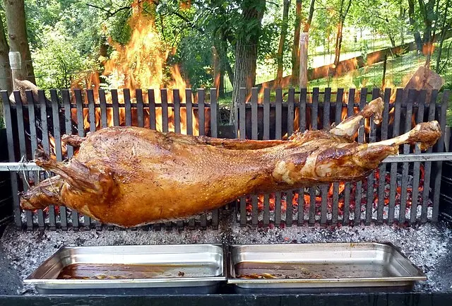 Moroccan Mechoui slow-roasted lamb rubbed with spiced butter on a serving platter, a North African celebration dish