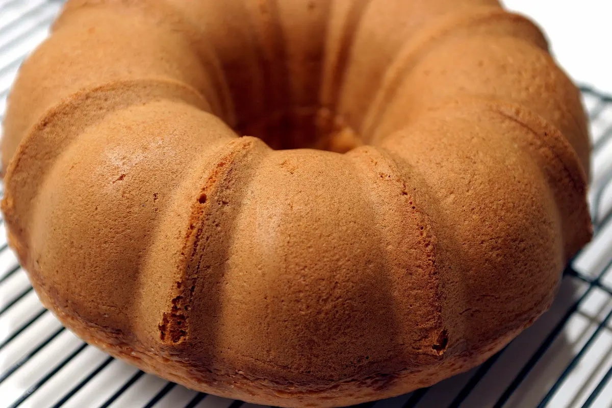 Moroccan Mescouta yoghurt cake dusted with icing sugar on a plate, a light fragrant North African bake