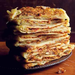 Algerian Mhadjeb stuffed flatbread cooked on a griddle, a popular North African street food with spiced onion filling