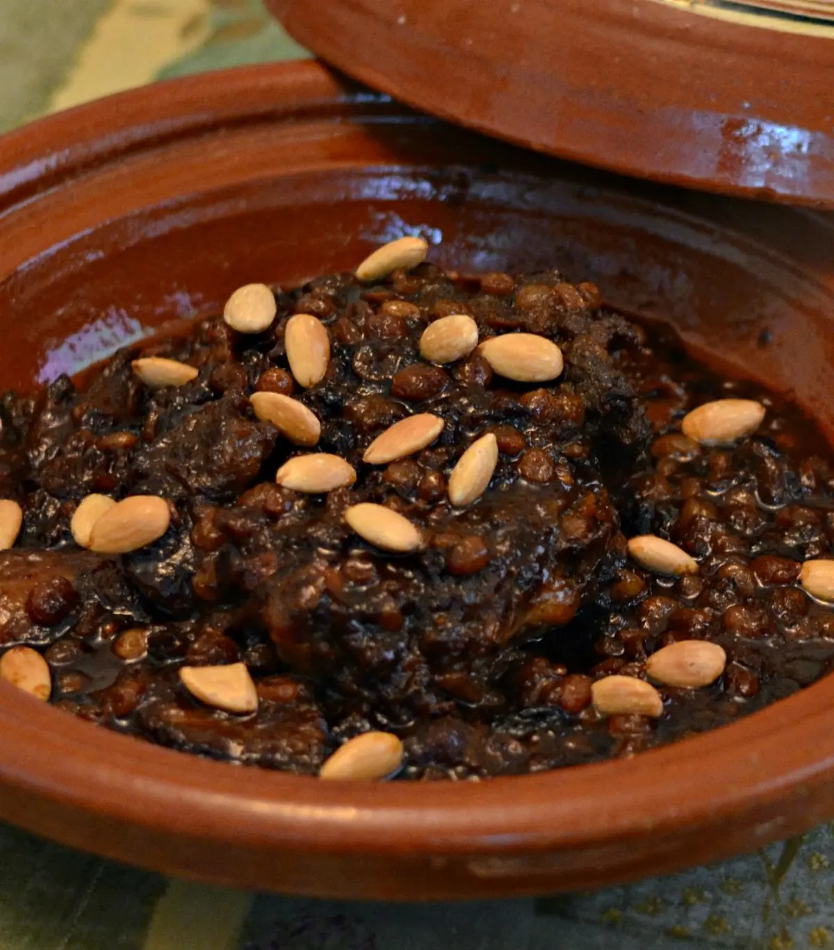 Moroccan Mrouzia sweet lamb tagine with raisins, almonds, and honey in a tagine pot, a royal Moroccan celebration dish