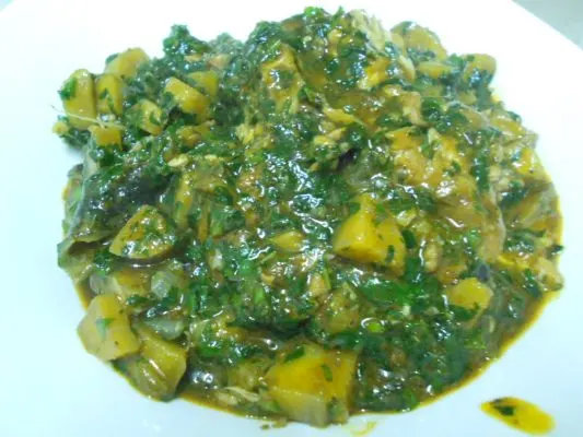 Nigerian Plantain Porridge with unripe plantain, palm oil, and spinach in a pot, a West African one-pot meal