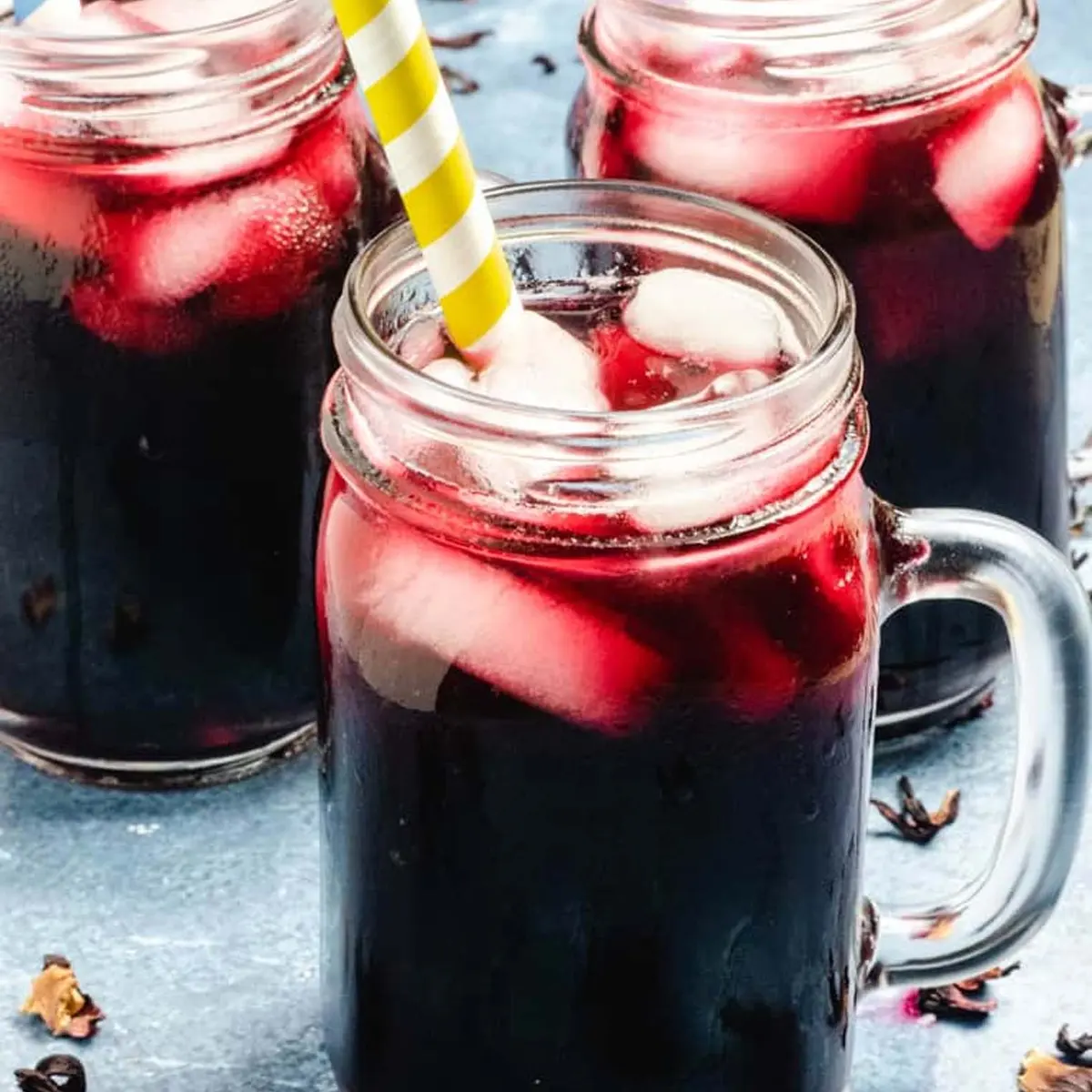 Nigerian Zobo Drink deep red hibiscus tea in a glass with ice, West Africa's most popular natural herbal beverage