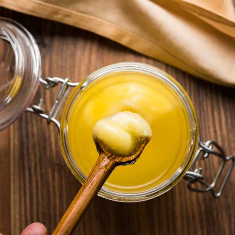 Niter Kibbeh Ethiopian spiced clarified butter in a jar, golden and aromatic with spices for Ethiopian cooking