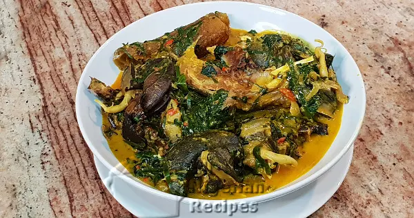 Ofe Owerri Igbo soup in a pot with cocoyam, ugu leaves, and assorted protein, a traditional soup from Imo State Nigeria