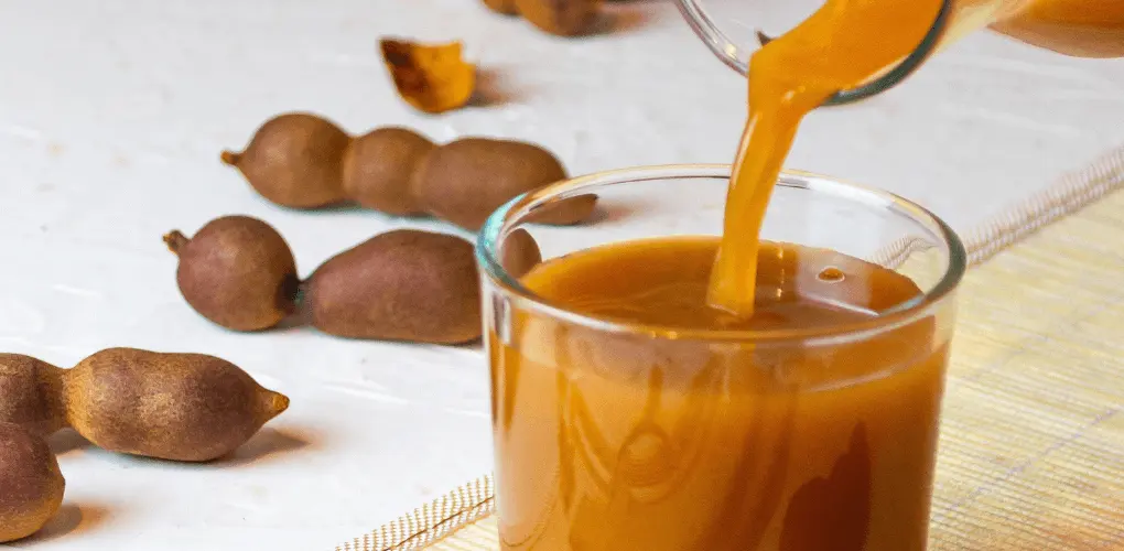 West African Tamarind Juice in a glass with ice, a tangy refreshing drink made from tamarind pods popular across West Africa