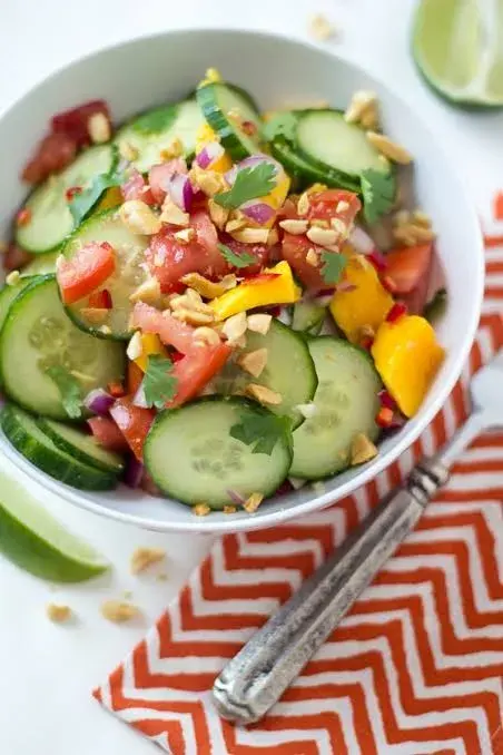 African mango and cucumber salad with tomato, chilli, coriander and roasted peanuts