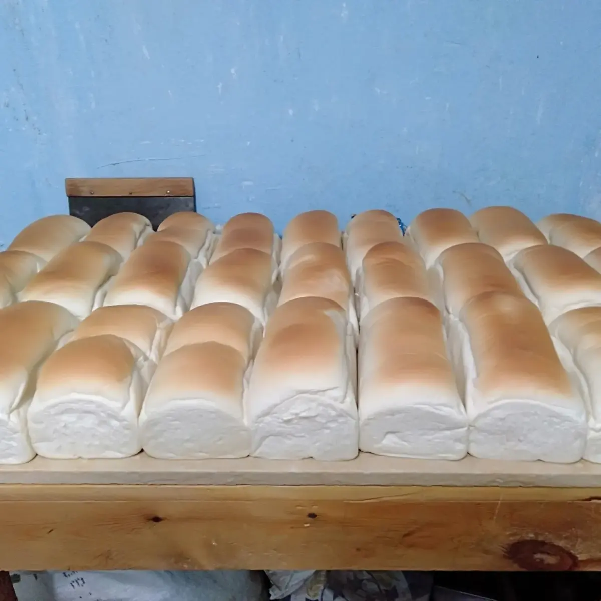 Agege bread, a soft slightly sweet Nigerian loaf from Lagos, torn open to show the pull apart crumb