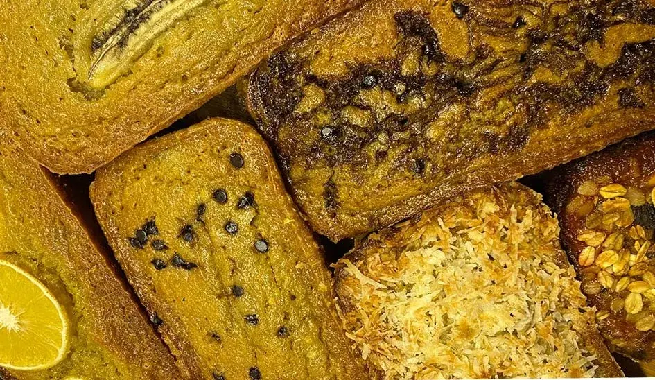 A sliced loaf of moist banana bread with chocolate chips