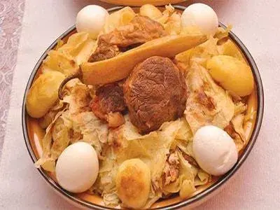 Chekhchoukha, Algerian torn rougag flatbread under a spiced meat and chickpea sauce