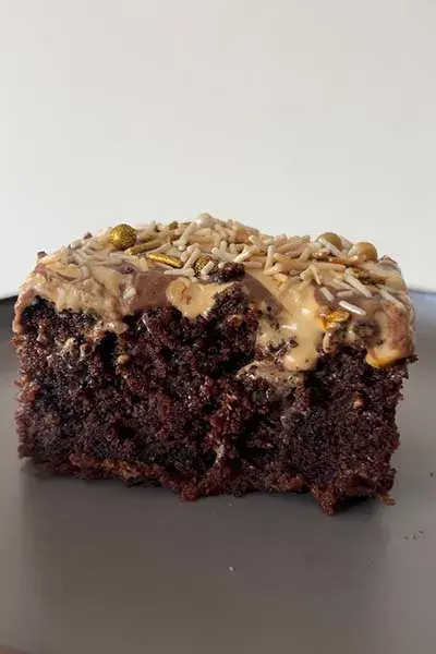 A layered chocolate cake with caramel cream icing