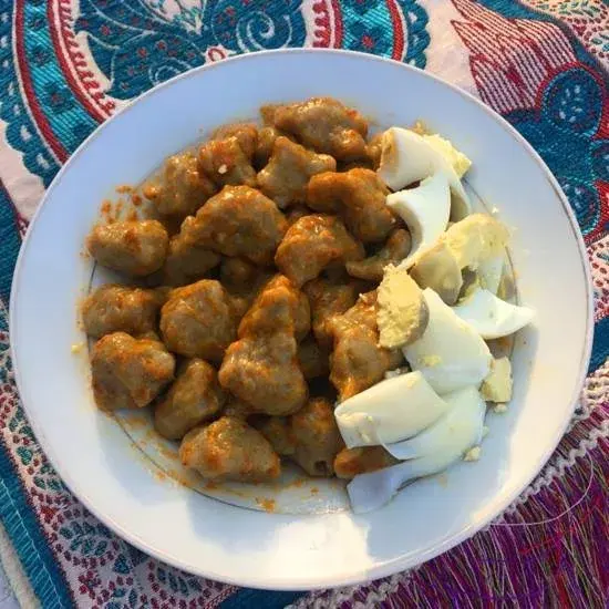 Dan wake, northern Nigerian bean flour dumplings with baobab leaf, served with spice and salad