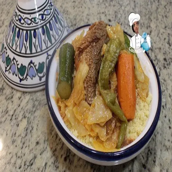 Fish and vegetable couscous with harissa broth, served in a deep dish