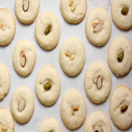 Ghorayebah, pale Egyptian ghee shortbread cookies each topped with a clove