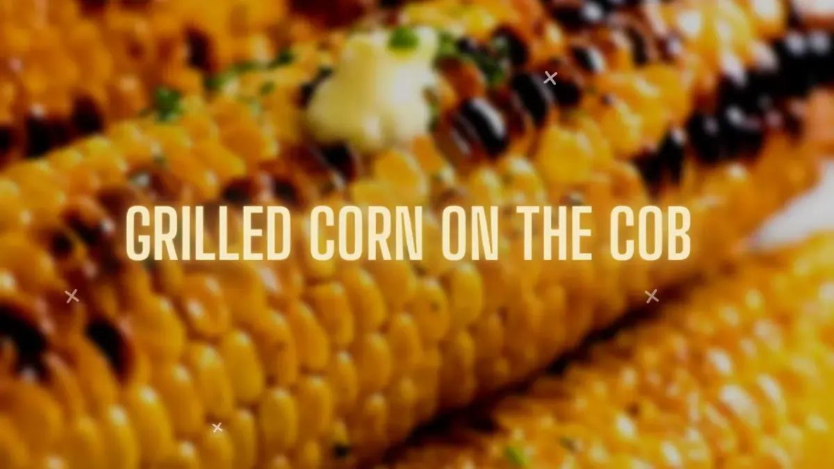 Grilled corn on the cob in its husk, buttered and lightly charred