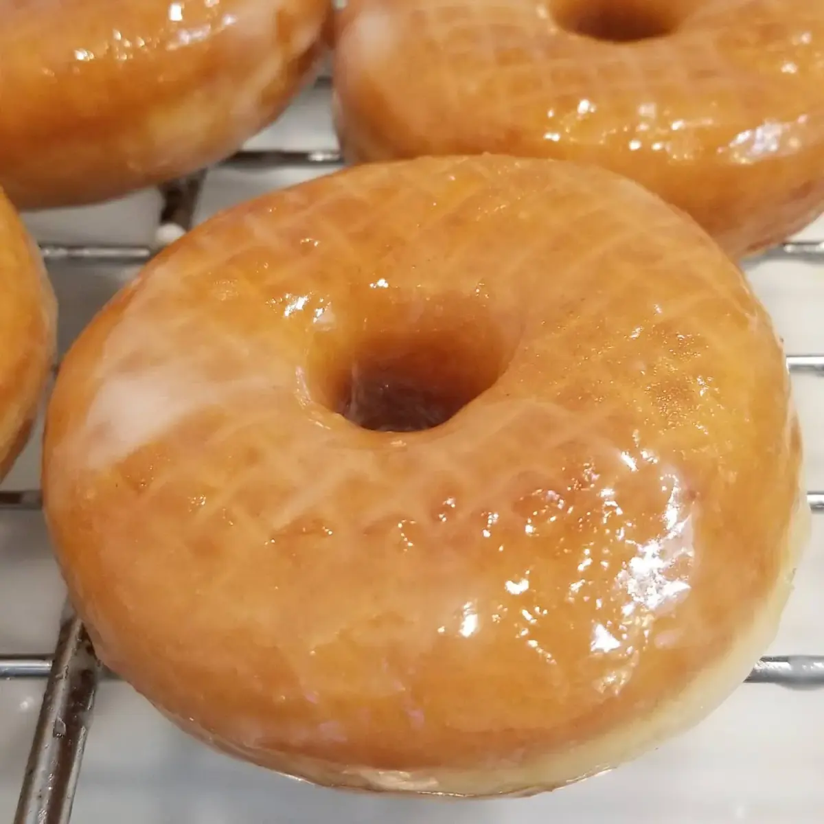 Homemade raised donuts, light yeasted rings fried golden and glazed