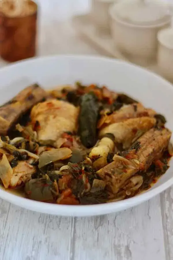 Igisafuri, a Rwandan one pot stew of chicken, plantain, spinach and vegetables