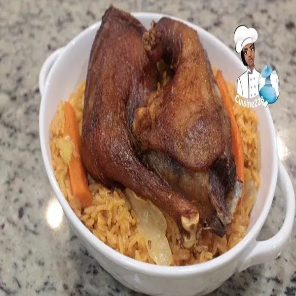 Ivorian jollof rice, a tomato based rice cooked with cabbage and carrot and served with fried chicken