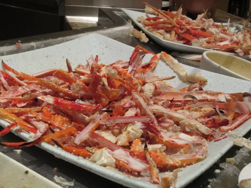 Steamed king crab legs served with melted butter and lemon wedges