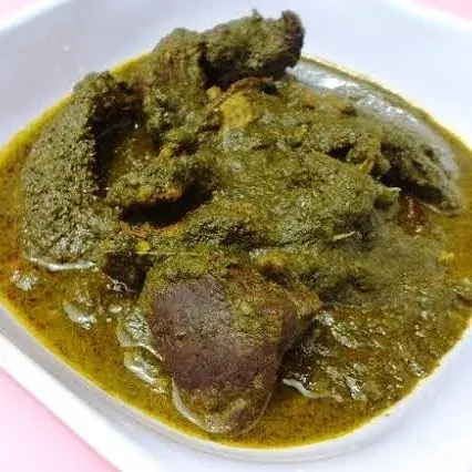 Marugbo soup, a dark Nigerian vegetable soup with goat meat and smoked fish