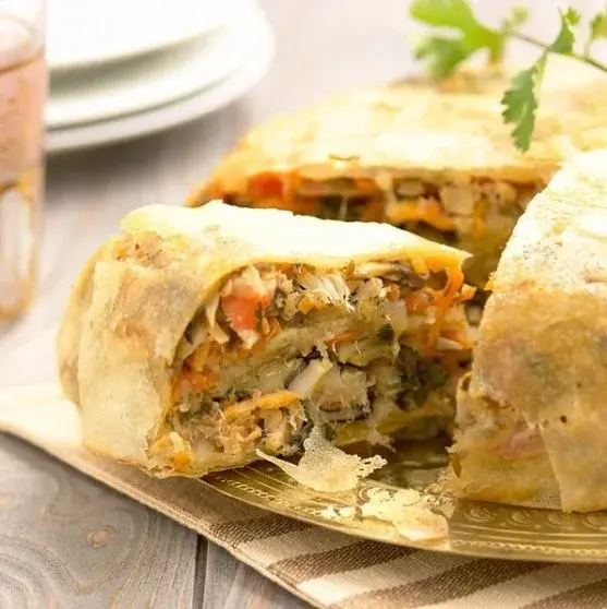 Moroccan pastilla, a layered pastry of spiced chicken and almonds dusted with icing sugar