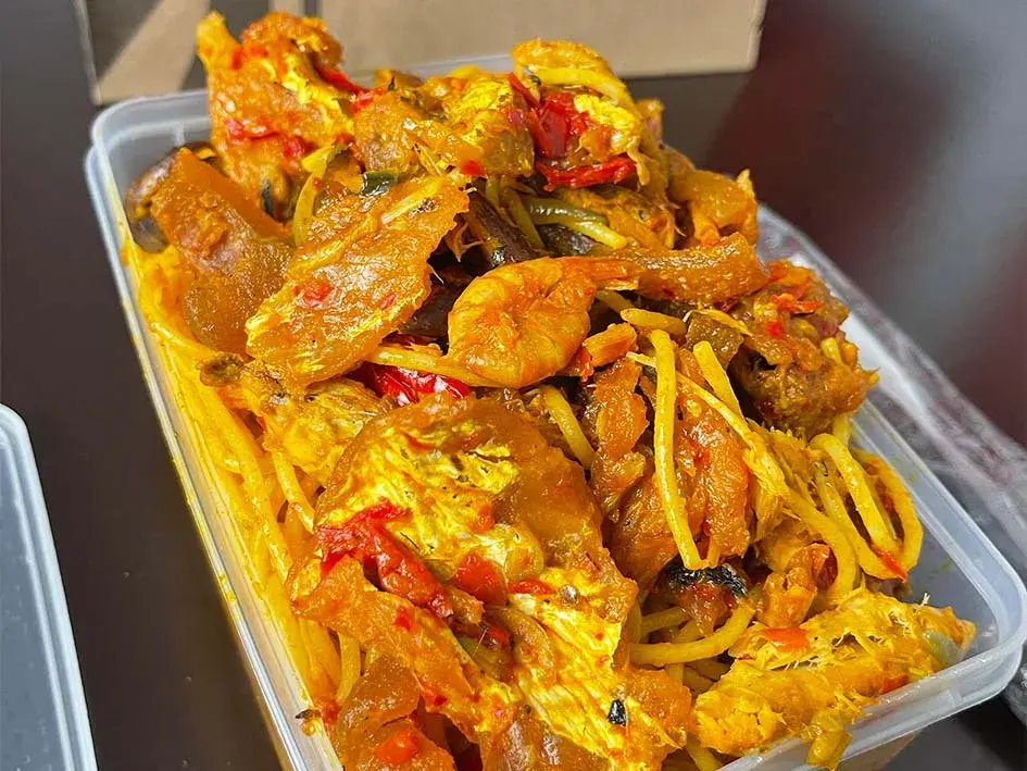 Nigerian native spaghetti cooked in palm oil with crayfish, dried fish and scotch bonnet peppers