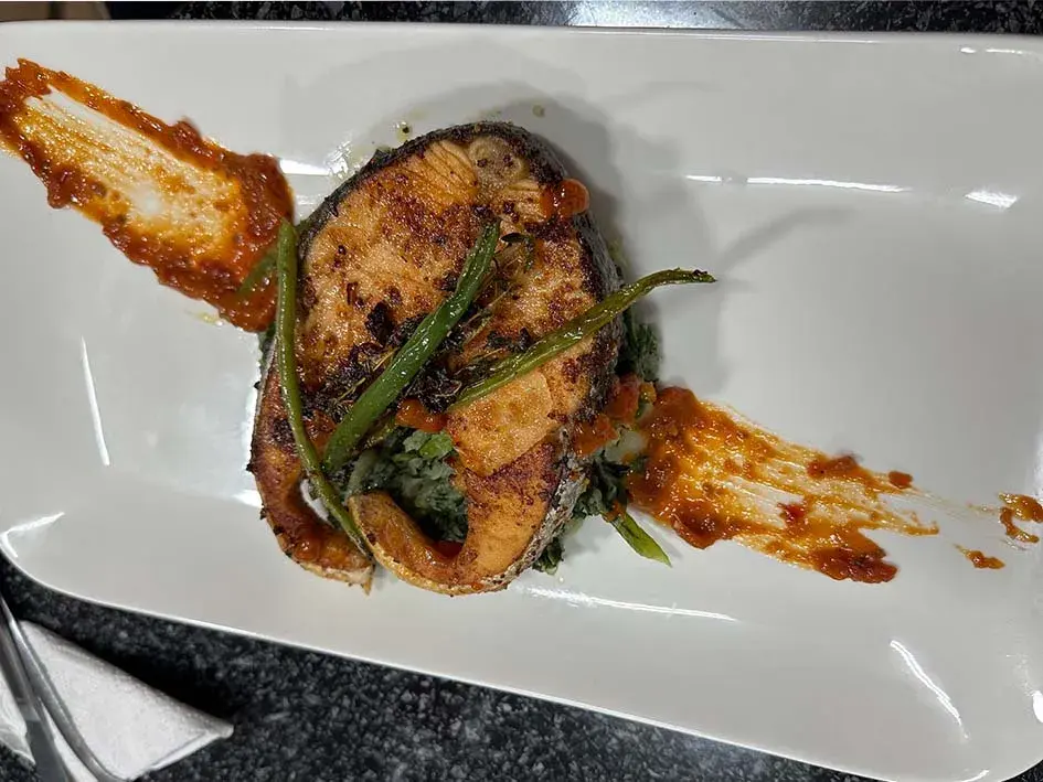 Pan-seared salmon steak cooked in garlic butter with thyme