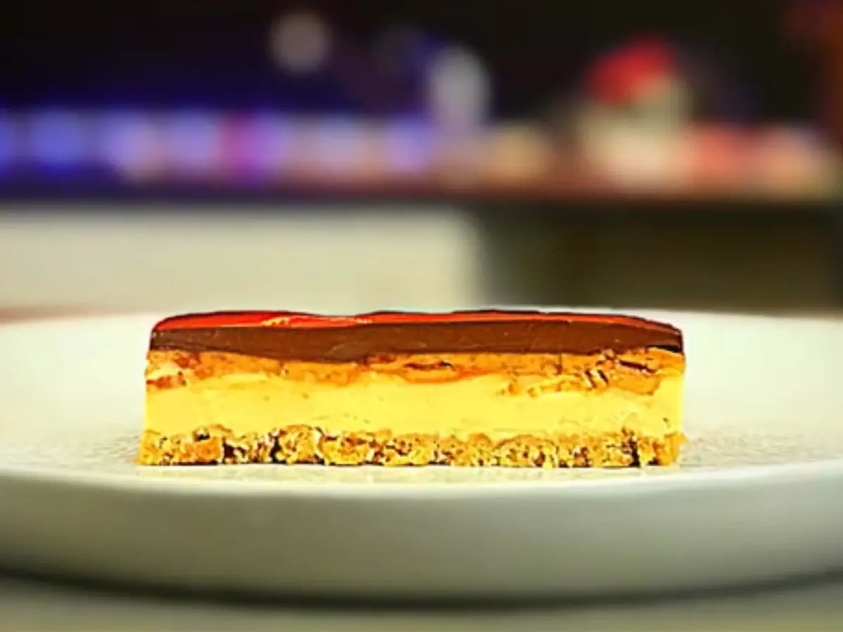 Peanut butter cheesecake with a biscuit base, fudge layer and chocolate ganache