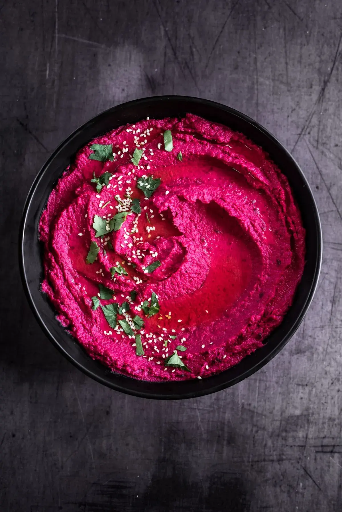 Beetroot and tahini dip topped with olive oil and pine nuts
