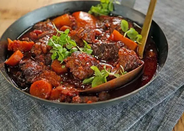 Tomato bredie, a South African lamb stew slow cooked with tomato into a thick red gravy
