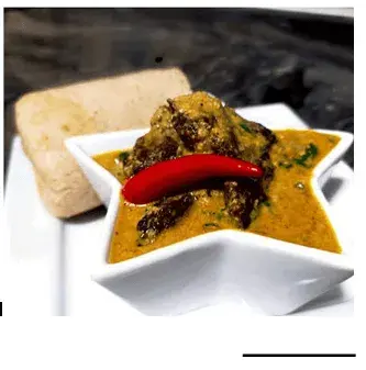 Vegan egusi soup with ground melon seed, mushrooms, spinach and palm oil
