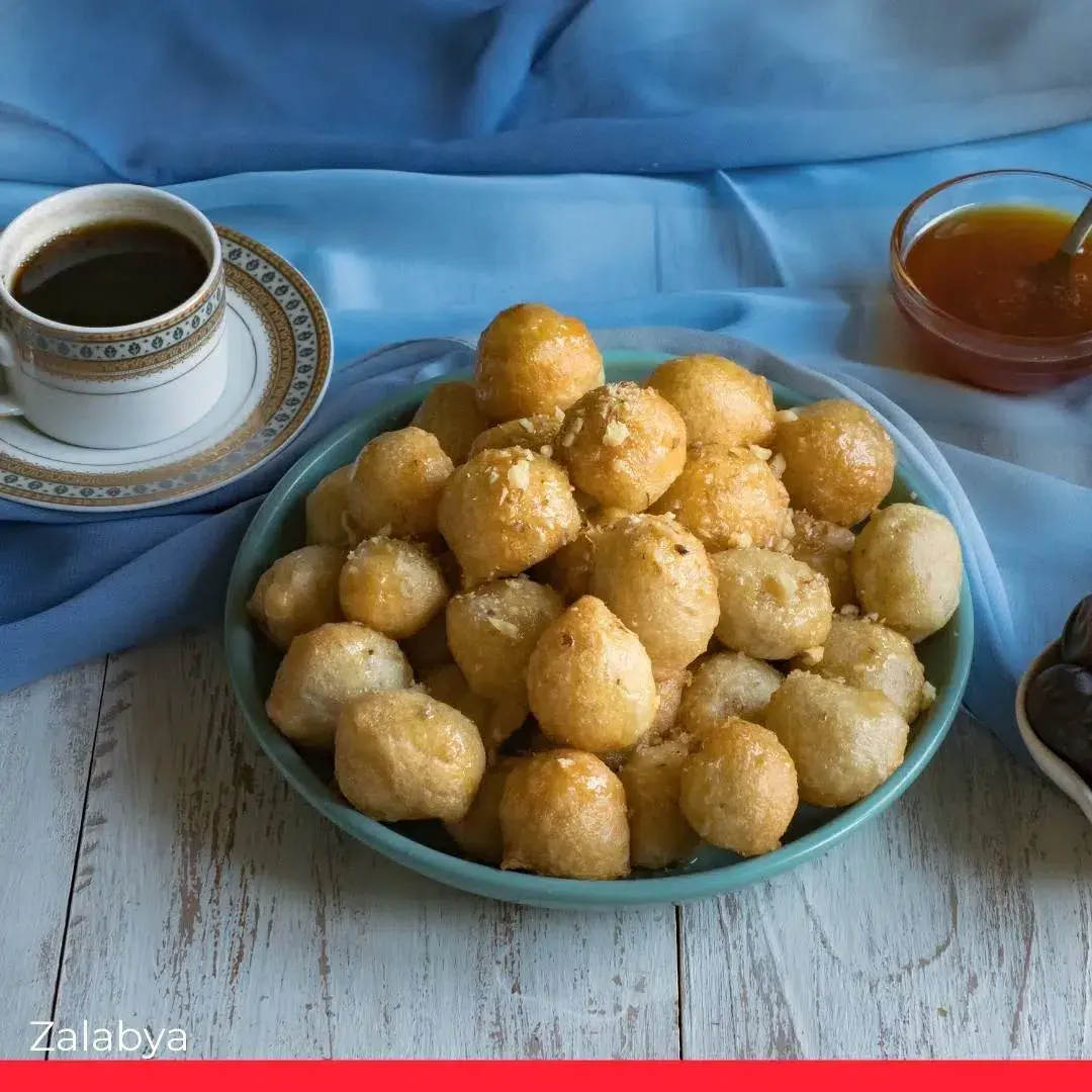 Zalabya, small Egyptian doughnuts dipped in syrup and dusted with cinnamon