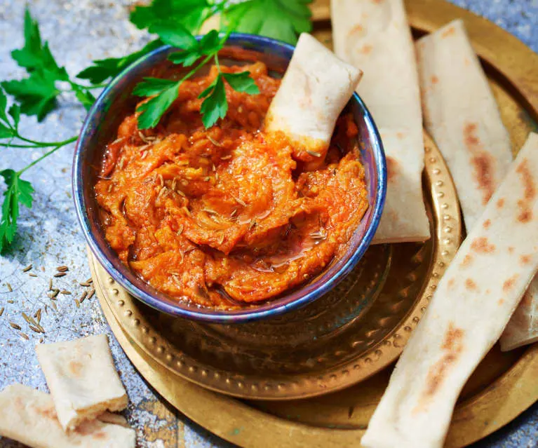 Moroccan Zaalouk cooked eggplant and tomato salad with cumin and herbs in a bowl, a classic Moroccan mezze dish