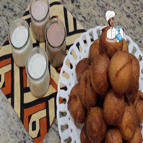 South African Donut Balls rolled in cinnamon sugar on a serving plate, golden fried dough balls