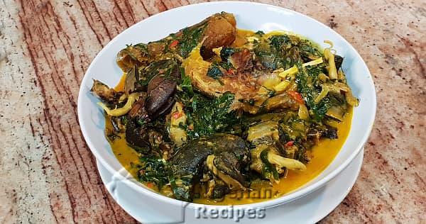 Ofe Owerri Igbo soup in a pot with cocoyam, ugu leaves, and assorted protein, a traditional soup from Imo State Nigeria