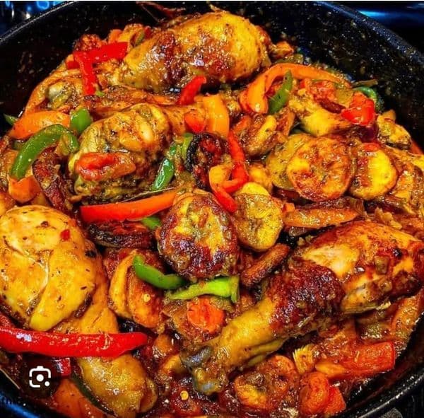 Poulet DG Cameroonian chicken with fried plantain and vegetables in a pot, Cameroon's celebrated prestige dish