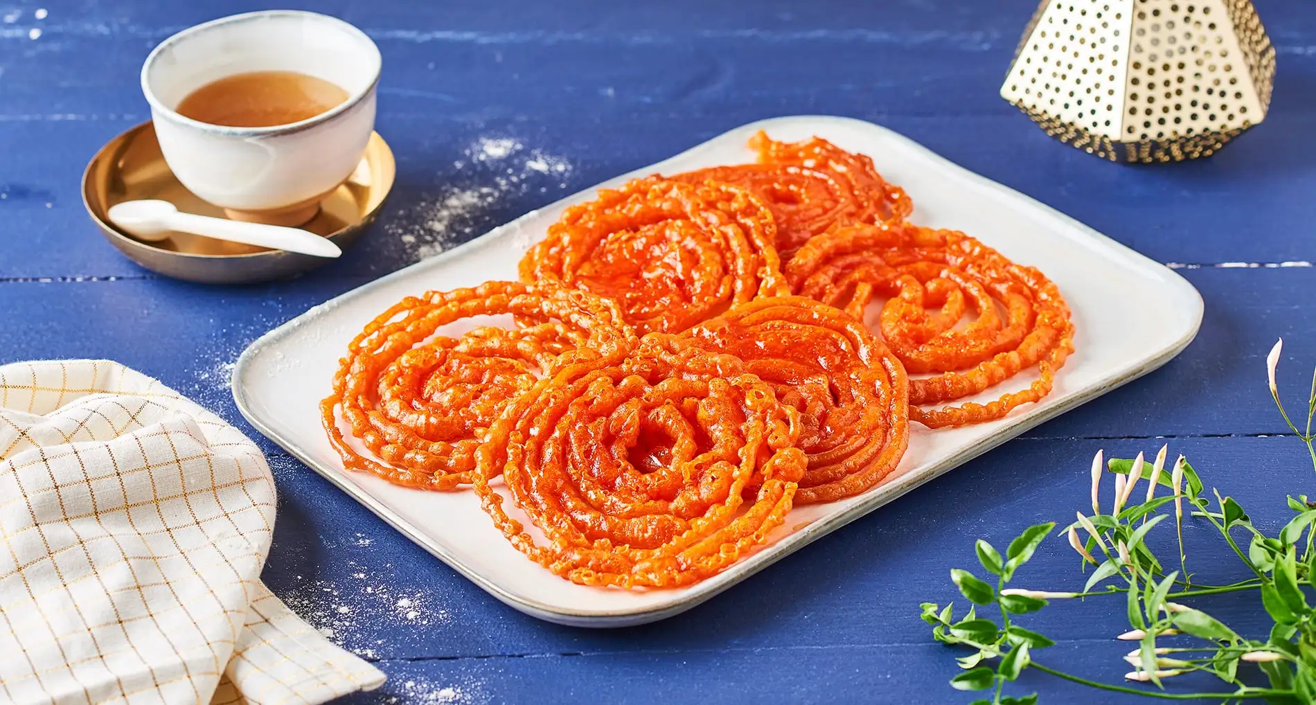 Tunisian Zlabia golden deep-fried spiral pastry soaked in honey syrup on a plate, a North African Ramadan sweet
