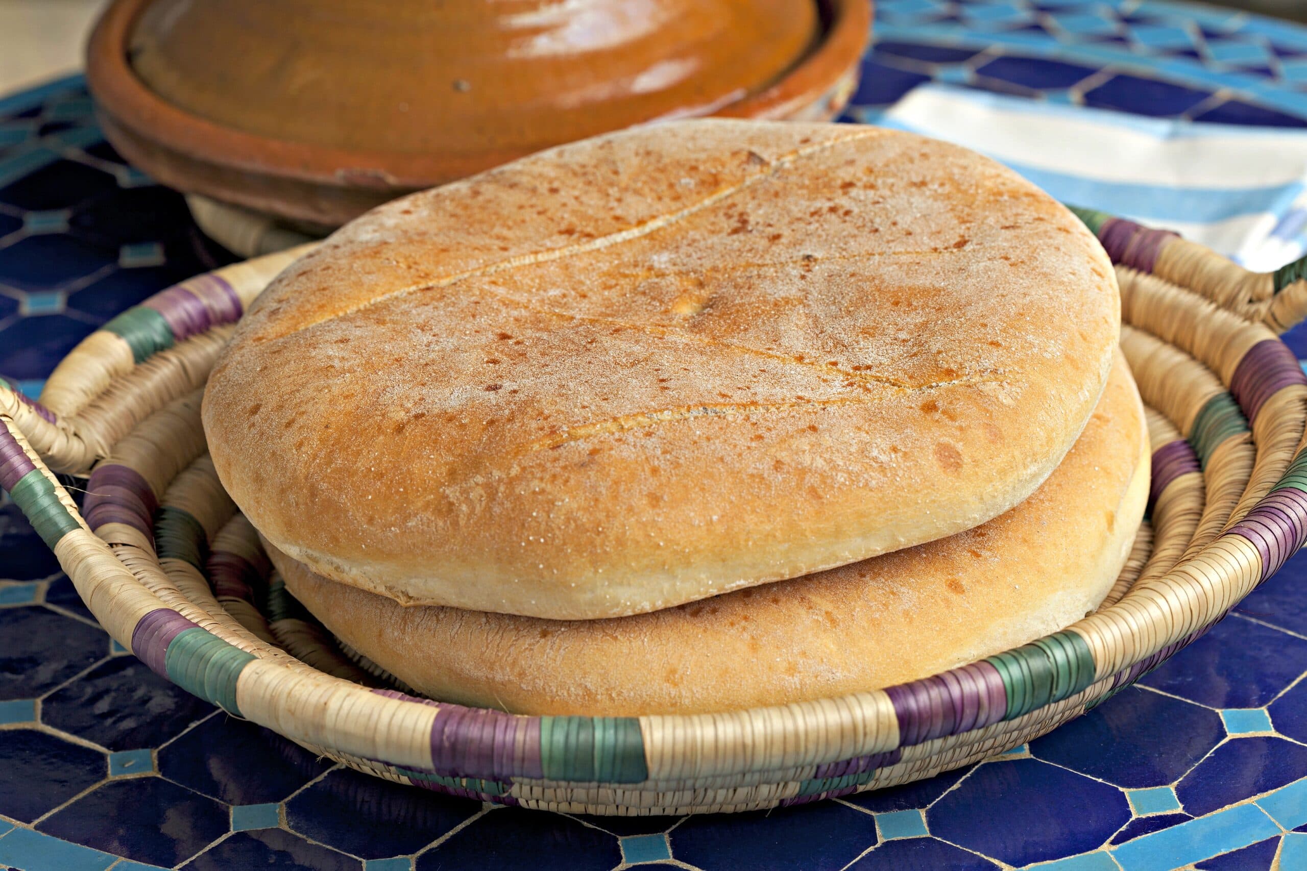Moroccan Khobz round sesame flatbread on a table, the traditional bread eaten with every Moroccan meal