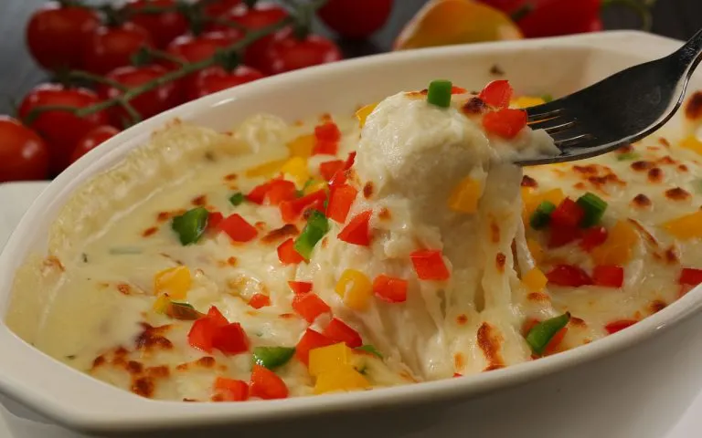 Egyptian Macarona Bechamel baked pasta with spiced minced meat and golden bechamel sauce in a baking dish