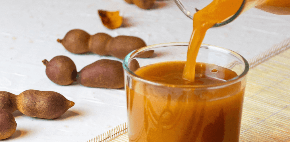 West African Tamarind Juice in a glass with ice, a tangy refreshing drink made from tamarind pods popular across West Africa