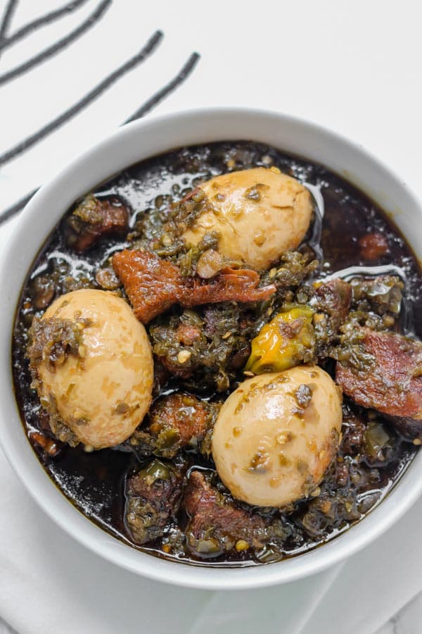 Ayamase Stew Nigerian green pepper designer stew with assorted meat, boiled eggs, and bleached palm oil, served with ofada rice
