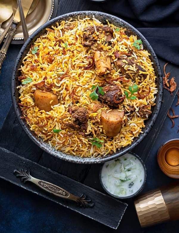 Cape Malay Biryani South African fragrant spiced rice with chicken and golden raisins in a pot, a Cape Malay celebration dish