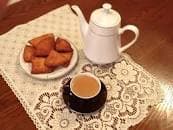 Mandazi East African fried dough pastry on a plate, a Swahili coast breakfast food from Kenya and Tanzania spiced with cardamom