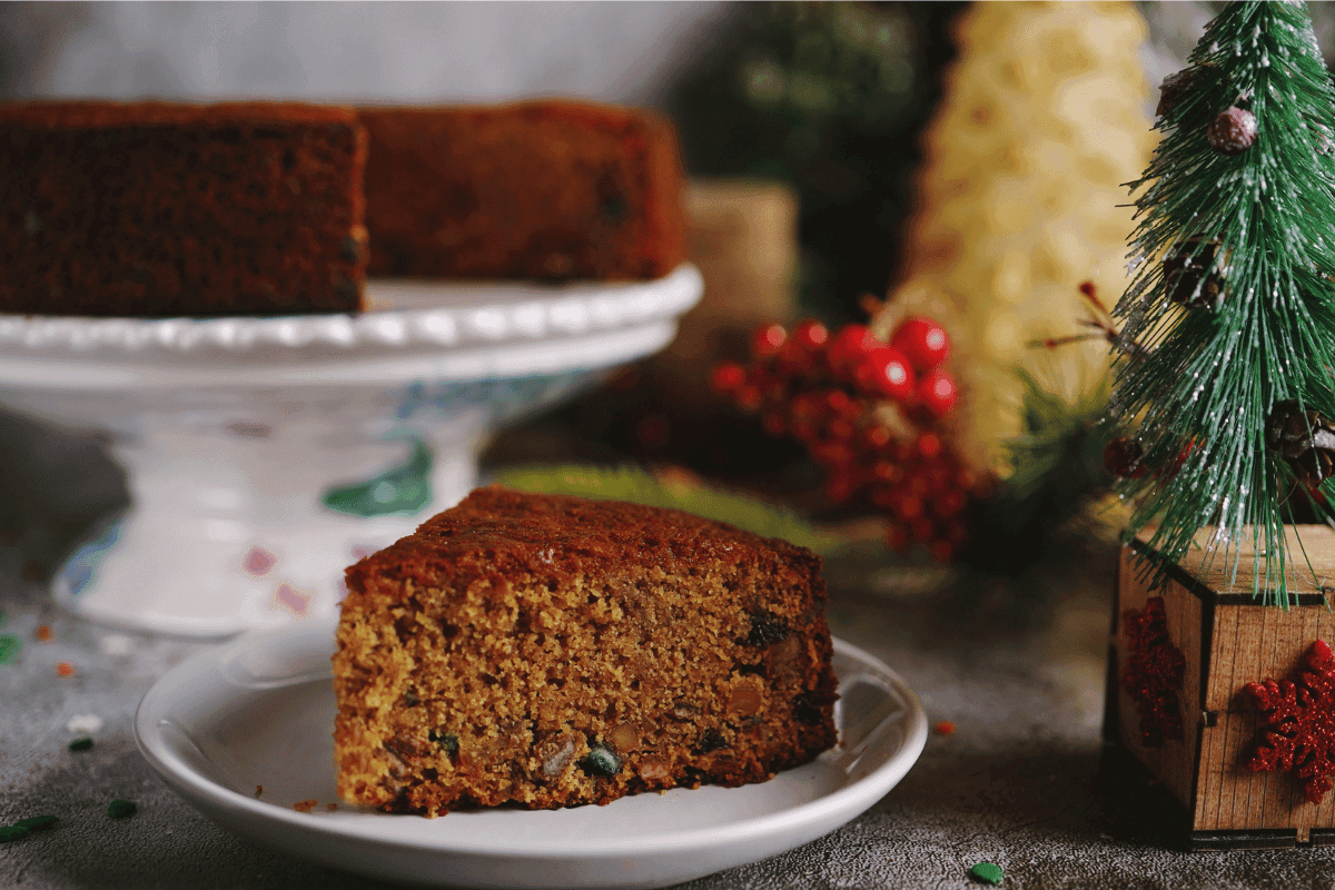 Nigerian Christmas Fruit Cake dark rich cake with soaked dried fruits sliced on a plate, a West African festive classic