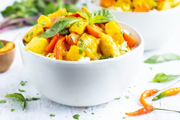 Nigerian Coconut Chicken Curry served in a bowl with rice, a West African dish made with fresh coconut milk and scotch bonnet peppers